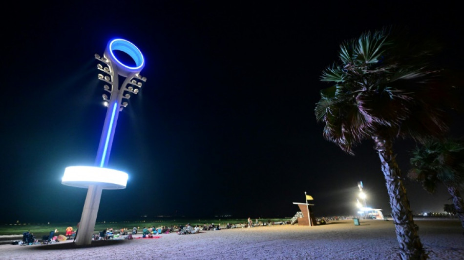 Too hot by day, Dubai's floodlit beaches are packed at night