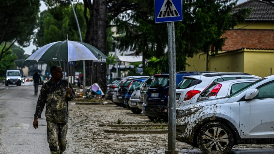 Bereft but alive: dazed residents clean-up after Italy floods