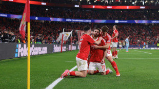 Benfica hold off Monaco to reach Champions League last 16